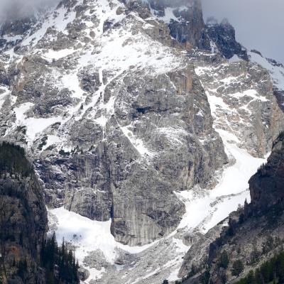 Grand Teton glacial valley, peaks with fresh snow, topped with clouds